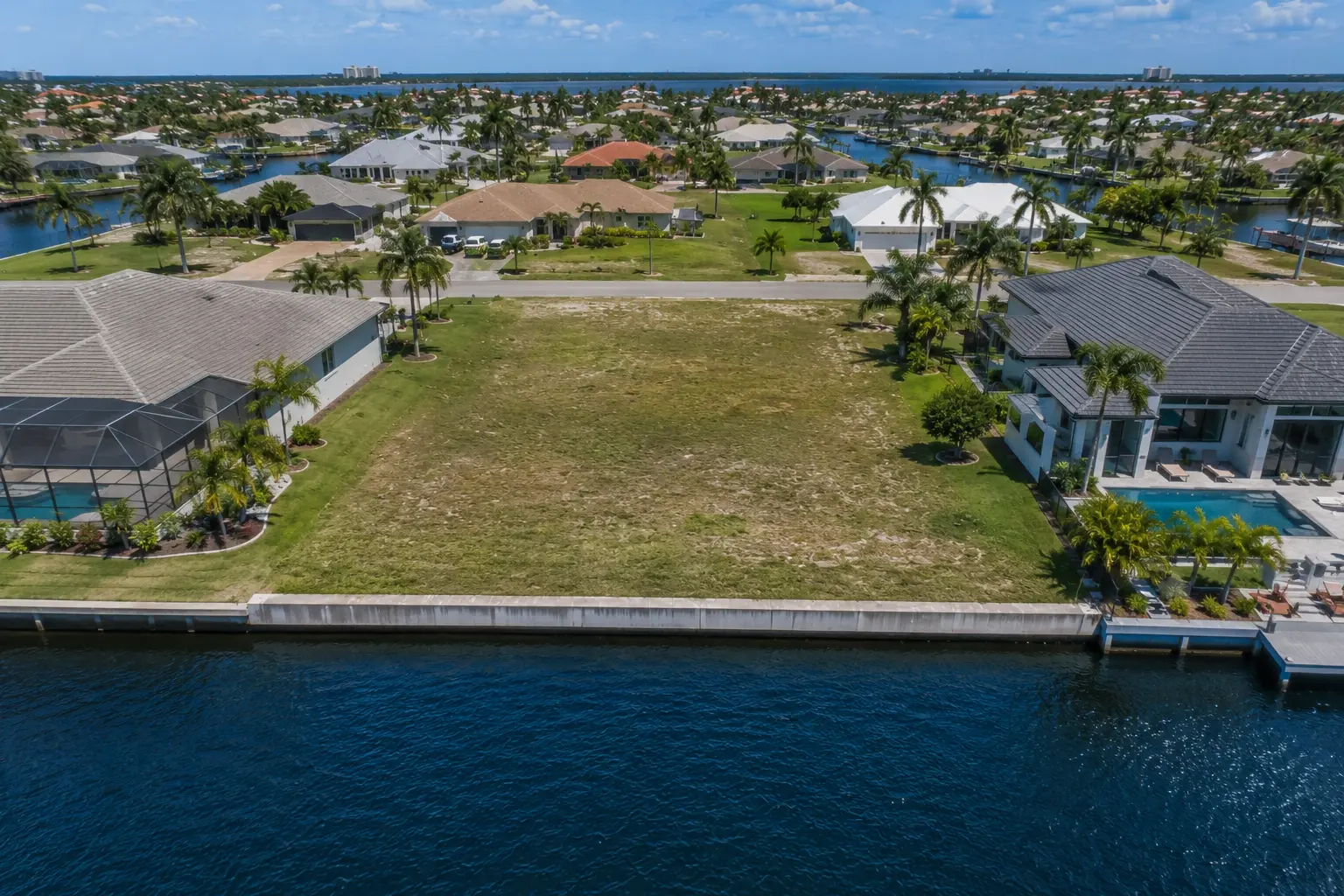 Cape Coral vacant land valuation based on waterfront access canal type sailboat access seawalls flood zones utilities and lot dimensions