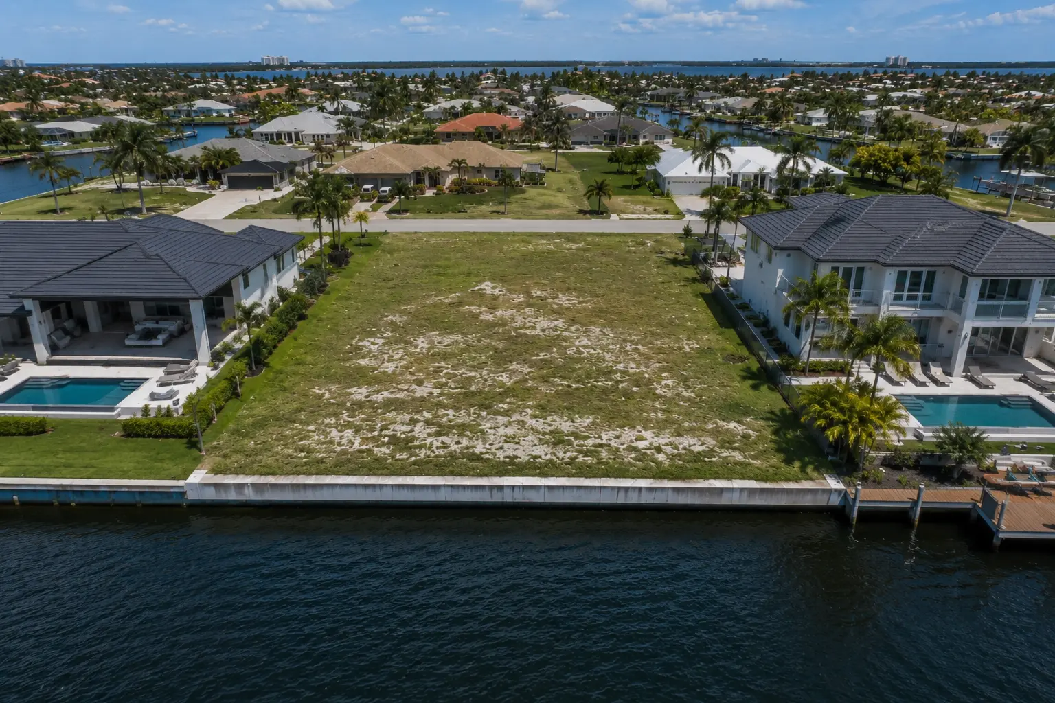 Cape Coral waterfront lot marketing with Gulf access freshwater access sailboat access canal width seawalls and builder suitability
